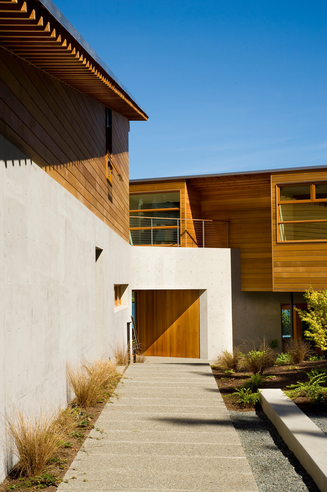 Design ideas for a large contemporary two-storey concrete exterior in Seattle.