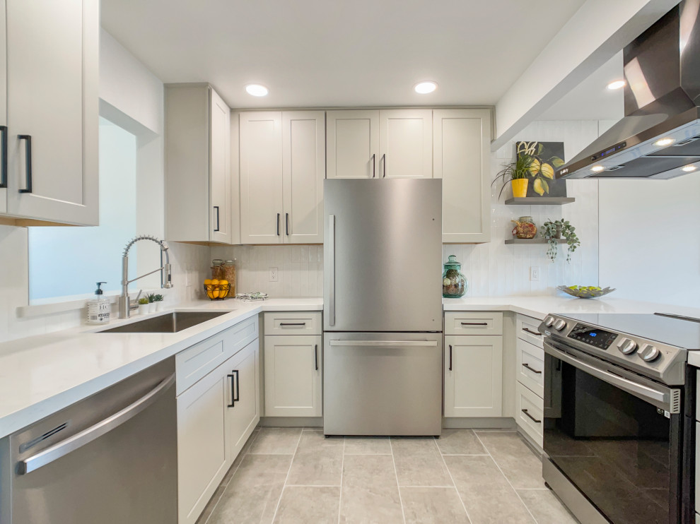 Enclosed kitchen - mid-sized contemporary u-shaped cement tile floor and gray floor enclosed kitchen idea in Other with an undermount sink, shaker cabinets, gray cabinets, quartz countertops, white backsplash, subway tile backsplash, stainless steel appliances, no island and white countertops