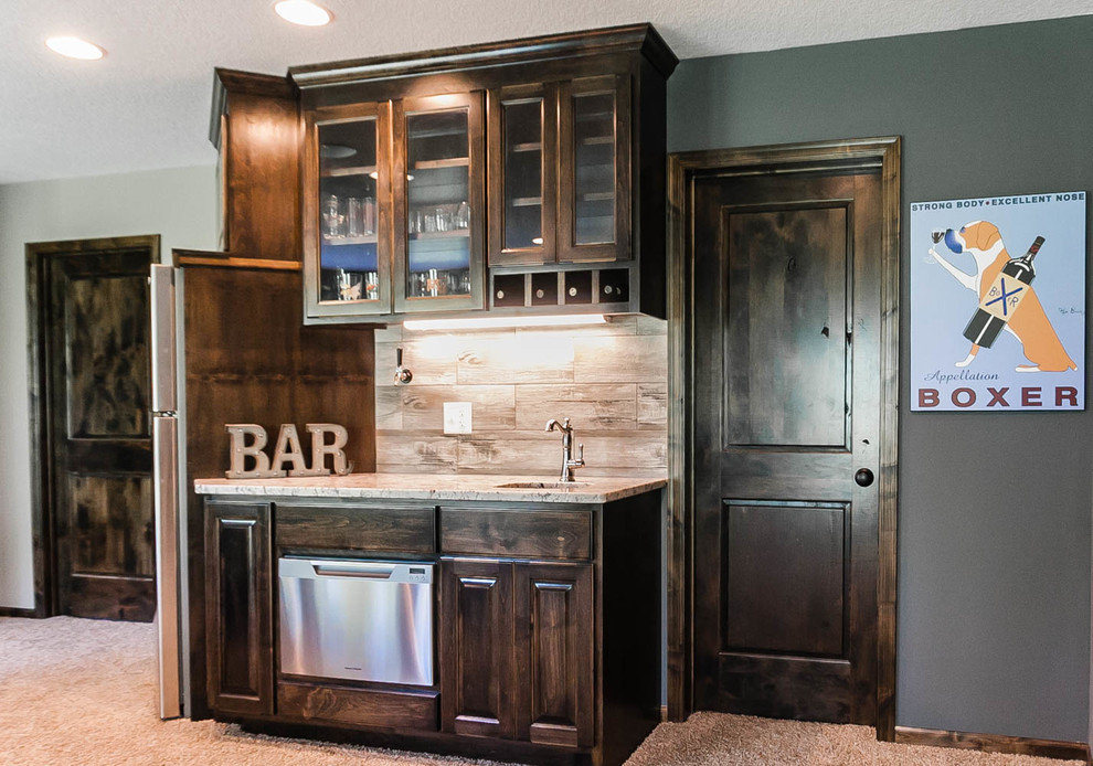 Design ideas for a small traditional galley wet bar in Minneapolis with an undermount sink, raised-panel cabinets, dark wood cabinets, granite benchtops, porcelain splashback and carpet.