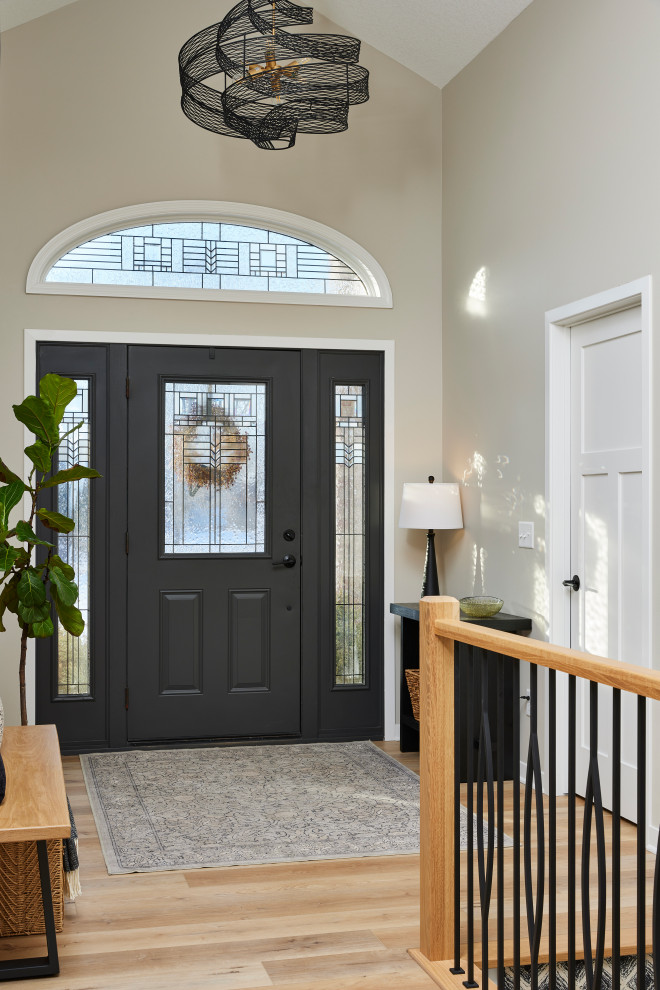 Mid-sized transitional vinyl floor and brown floor foyer photo in Minneapolis with beige walls and a black front door
