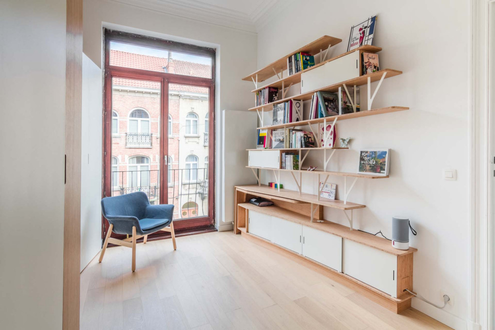 Mid-sized trendy built-in desk light wood floor, beige floor and tray ceiling home office library photo in Paris with white walls and no fireplace