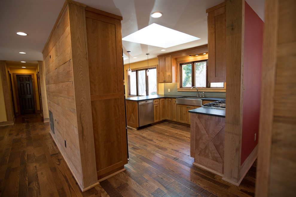 Inspiration for a large rustic u-shaped dark wood floor kitchen pantry remodel with a farmhouse sink, raised-panel cabinets, medium tone wood cabinets, blue backsplash, ceramic backsplash, stainless steel appliances and no island