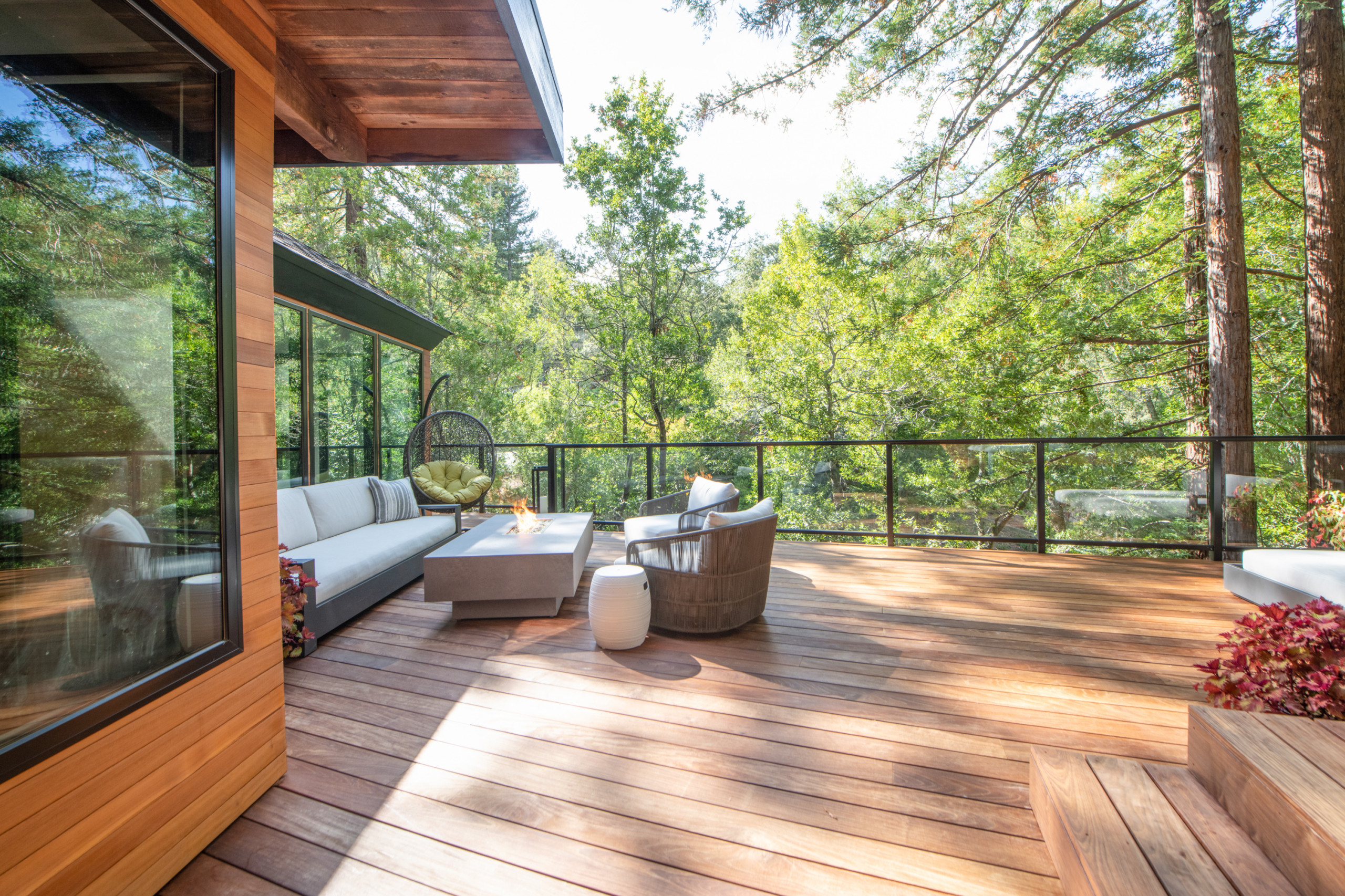Rooftop deck with wooden flooring and transparent glass railing