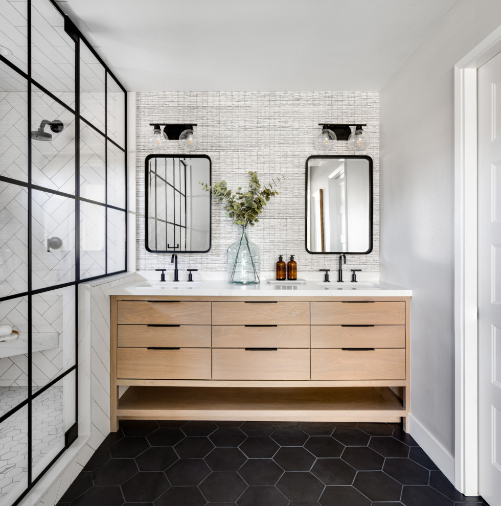 Inspiration for a medium sized classic ensuite bathroom in Orange County with flat-panel cabinets, light wood cabinets, a corner shower, white tiles, metro tiles, grey walls, porcelain flooring, a submerged sink, marble worktops, black floors, a hinged door, white worktops, an enclosed toilet, double sinks, a freestanding vanity unit and wallpapered walls.