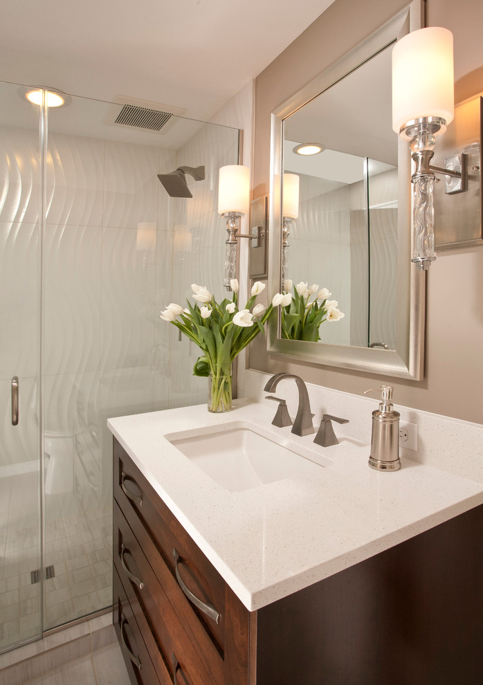 This is an example of a small transitional bathroom in Seattle with an undermount sink, shaker cabinets, dark wood cabinets, engineered quartz benchtops, white tile, porcelain tile, brown walls and porcelain floors.