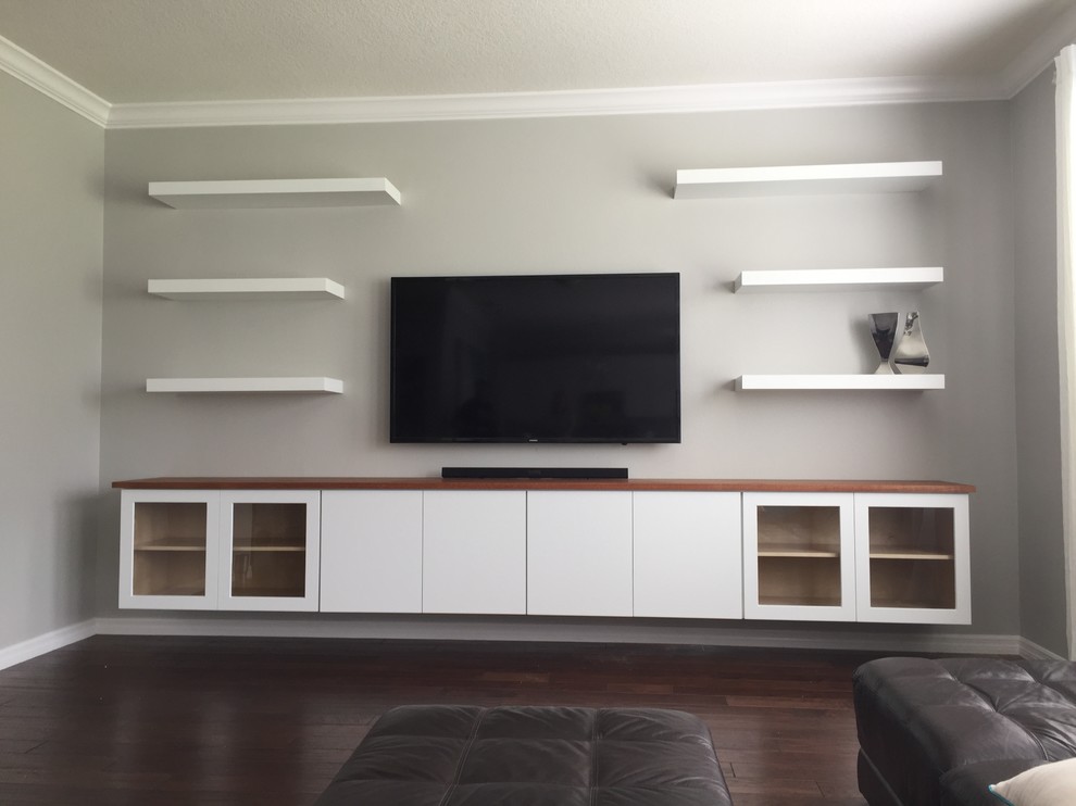 This is an example of a large modern family room in Orlando with a wall-mounted tv.