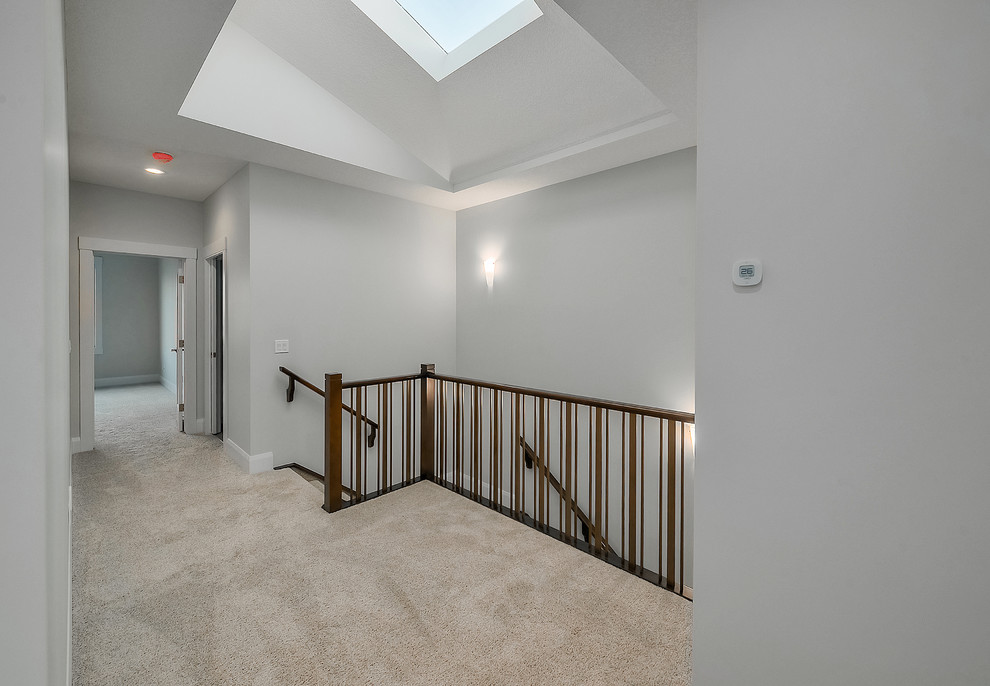 This is an example of a mid-sized modern carpeted u-shaped staircase in Calgary with concrete risers and mixed railing.