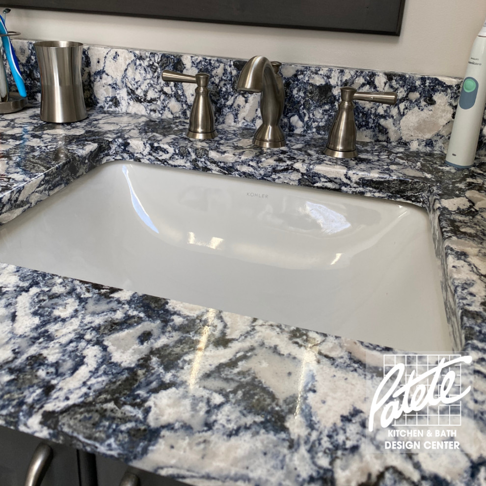 This is an example of a bathroom in Other with raised-panel cabinets, dark wood cabinets, beige tile, light hardwood floors, quartzite benchtops, blue benchtops, a double vanity and a built-in vanity.
