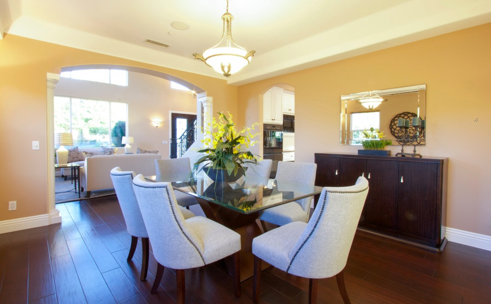 This is an example of a large contemporary separate dining room in Los Angeles with beige walls and dark hardwood floors.