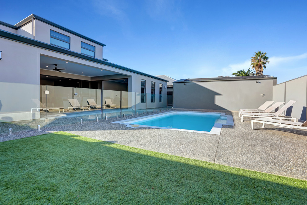 This is an example of a large contemporary rectangular pool in Adelaide with concrete slab.