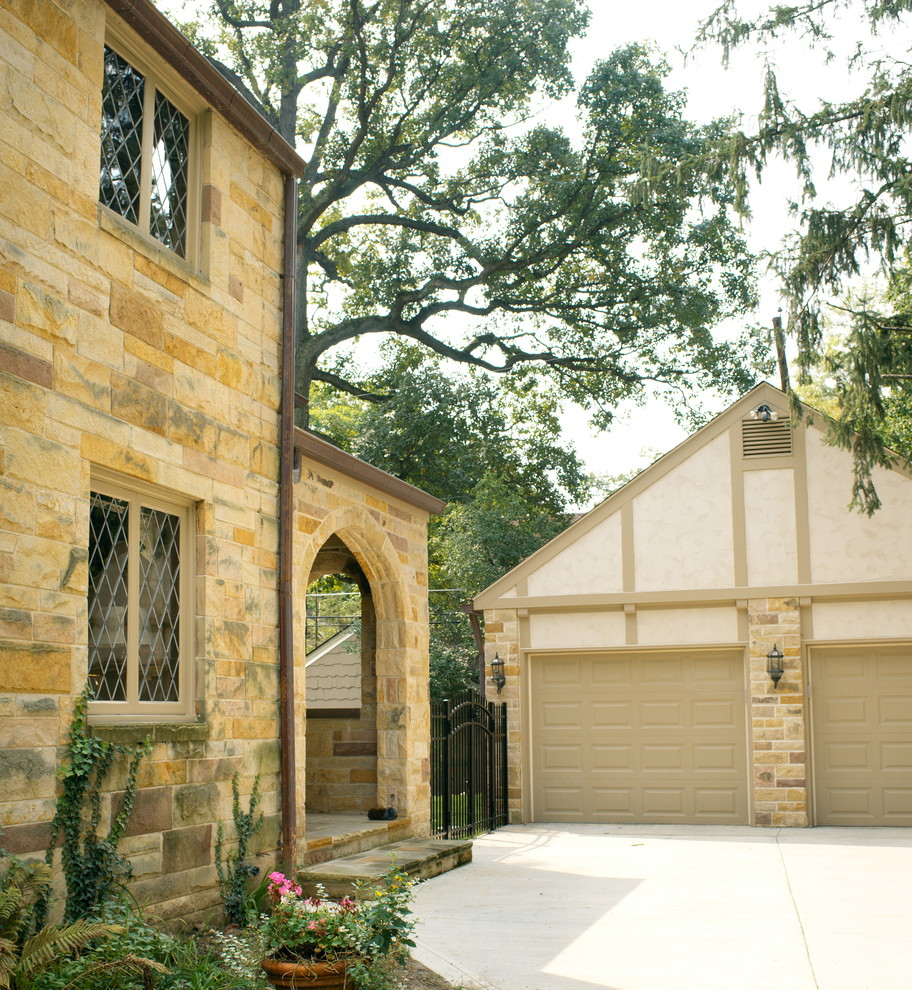 Design ideas for a mid-sized traditional two-storey beige exterior in Columbus with stone veneer.