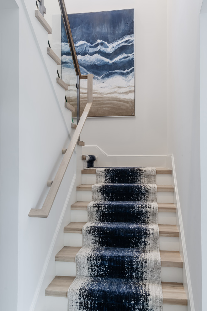 Example of a transitional carpeted u-shaped wood railing staircase design with wooden risers