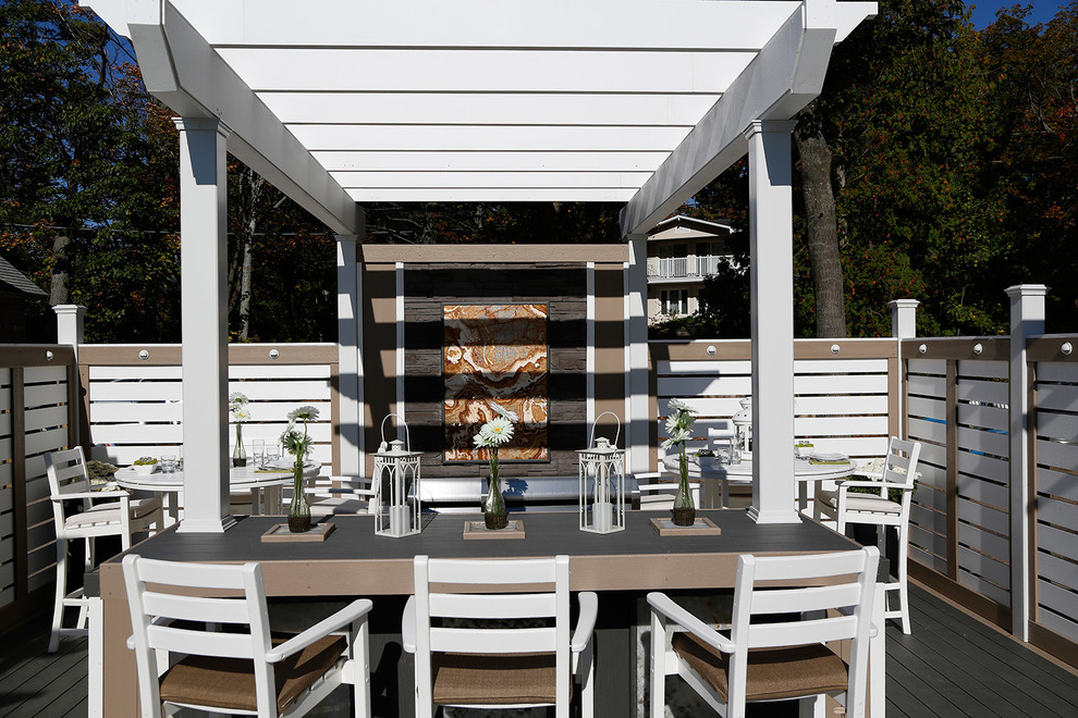 Inspiration for a large beach style courtyard deck in Toronto with a pergola.