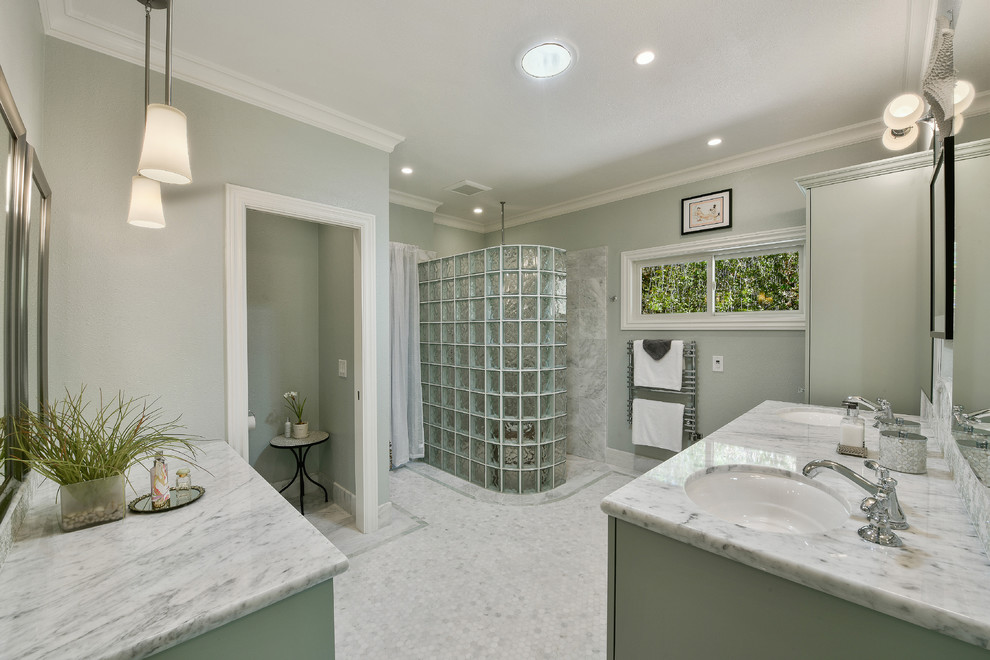 Inspiration for a mid-sized modern master bathroom in San Francisco with an undermount sink, raised-panel cabinets, green cabinets, marble benchtops, a curbless shower, a one-piece toilet, white tile, stone tile, green walls and mosaic tile floors.