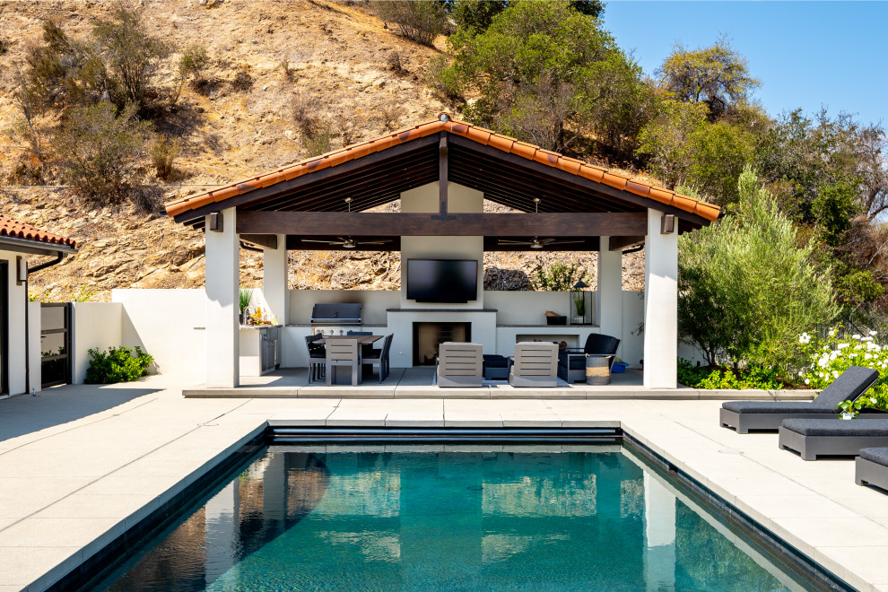 Design ideas for an expansive modern stucco white exterior in Los Angeles with a red roof.