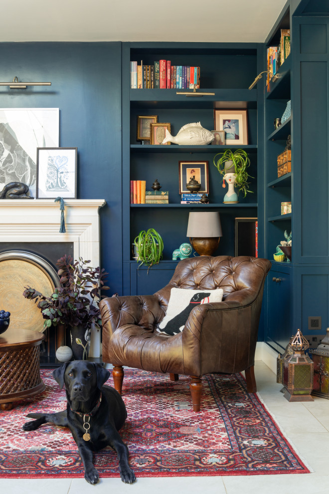 This is an example of a large bohemian home office in Hertfordshire with blue walls, porcelain flooring, a standard fireplace, a plastered fireplace surround, beige floors, a reading nook and a chimney breast.