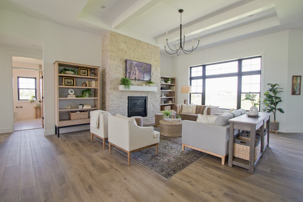 This is an example of a country formal open concept living room in Other with vinyl floors, a standard fireplace, a stone fireplace surround and exposed beam.