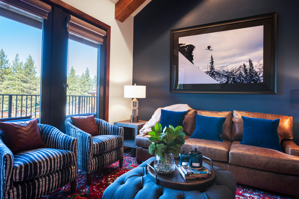 Mid-sized country open concept family room in Other with blue walls, carpet, a standard fireplace, a stone fireplace surround, a wall-mounted tv and multi-coloured floor.