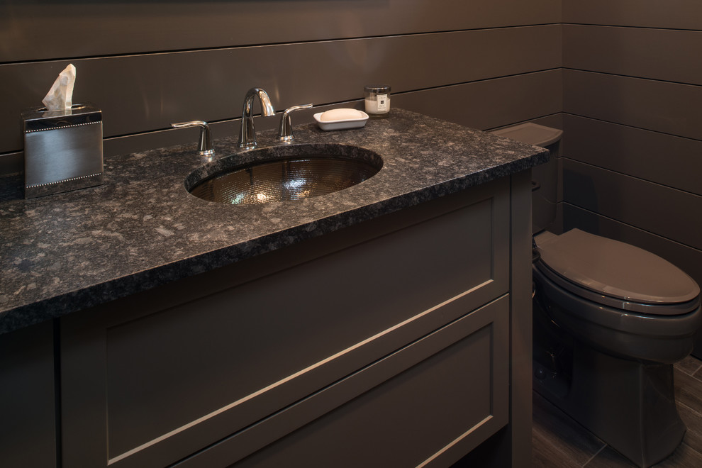 Bathroom - small transitional ceramic tile bathroom idea with shaker cabinets, gray cabinets, a two-piece toilet, gray walls, an undermount sink and granite countertops