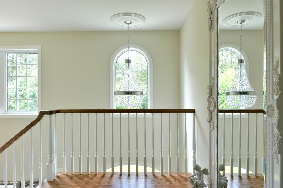 This is an example of a mid-sized traditional wood u-shaped staircase in Ottawa with painted wood risers.