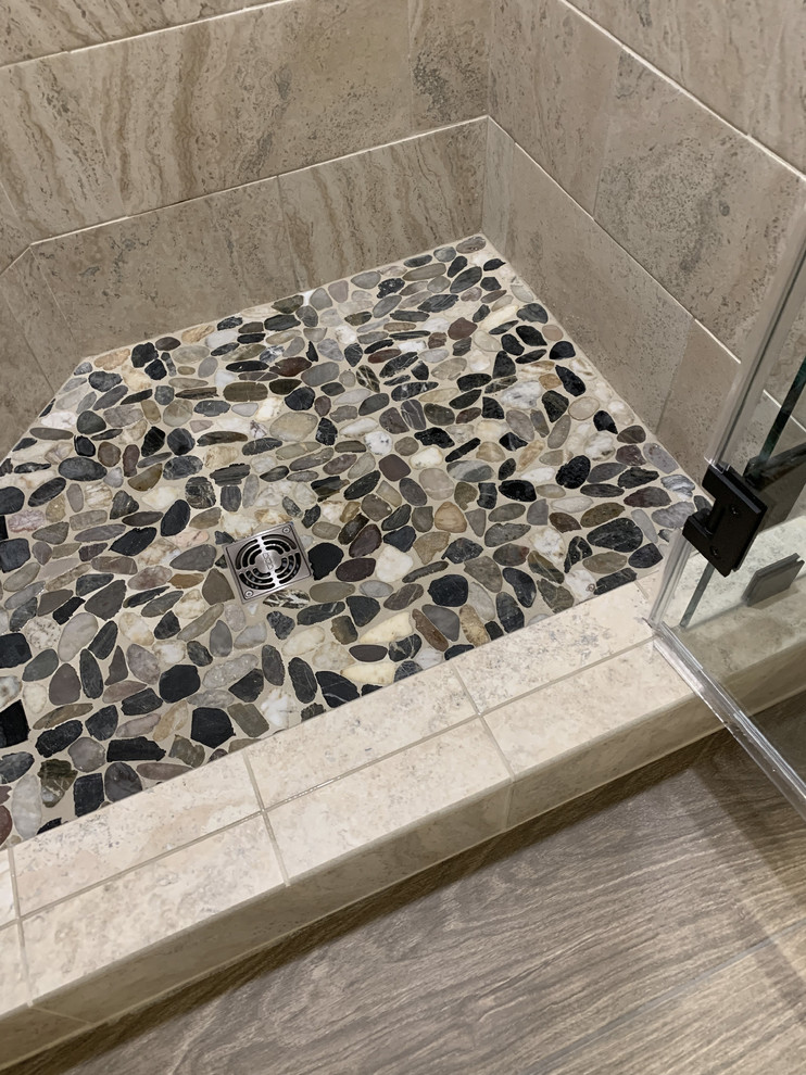 Inspiration for a large transitional master beige tile and ceramic tile linoleum floor and brown floor home design remodel with recessed-panel cabinets, white cabinets, a two-piece toilet, beige walls, an undermount sink, granite countertops, a hinged shower door and multicolored countertops