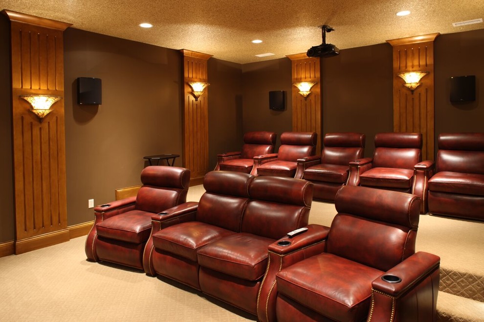 Photo of an expansive arts and crafts enclosed home theatre in Other with brown walls, carpet, a projector screen and beige floor.