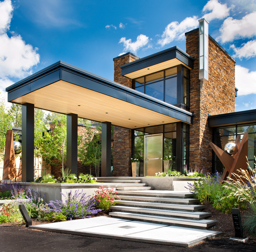 Contemporary exterior in Other with stone veneer.