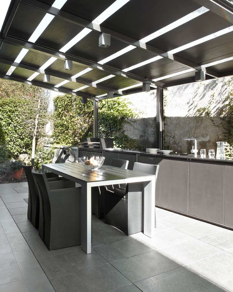 This is an example of a mid-sized contemporary patio in Other with a pergola.