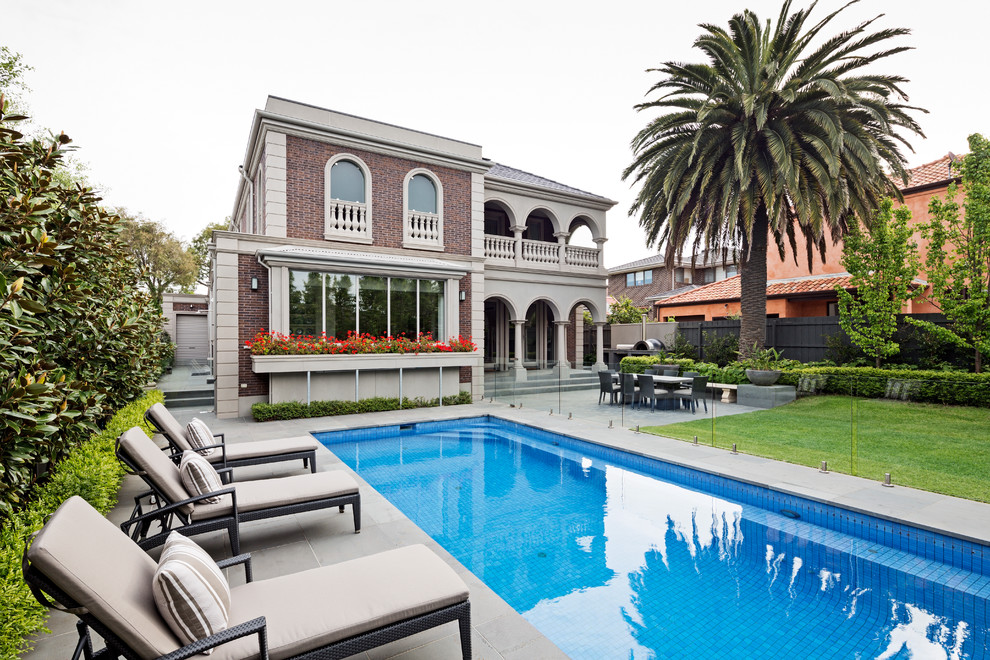 Traditional backyard rectangular lap pool in Melbourne with concrete pavers.