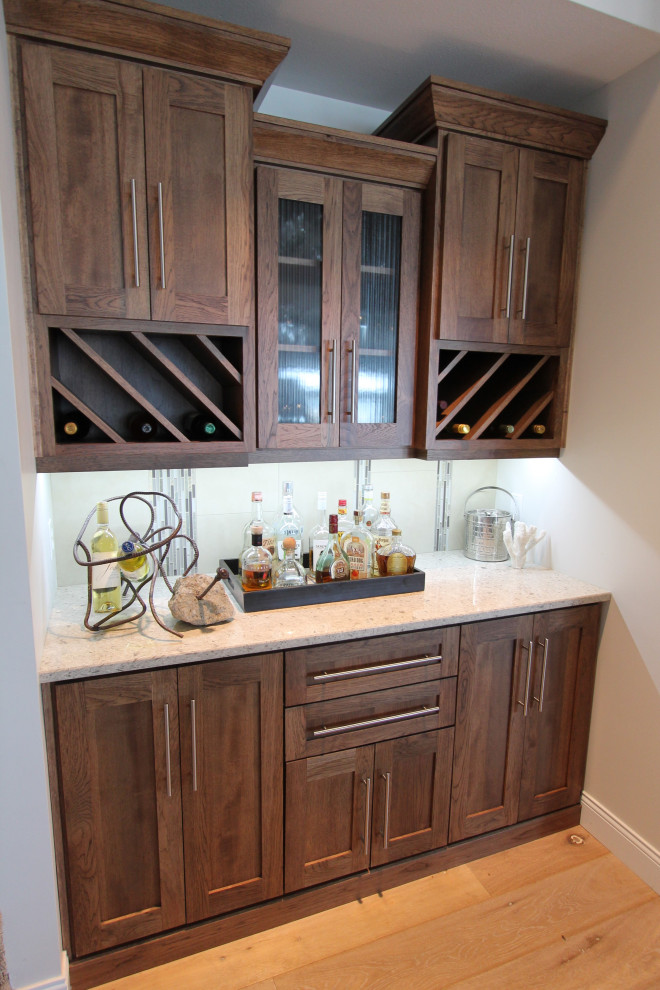 Small beach style home bar in Other with shaker cabinets, medium wood cabinets, quartzite benchtops, multi-coloured splashback, mosaic tile splashback and beige benchtop.