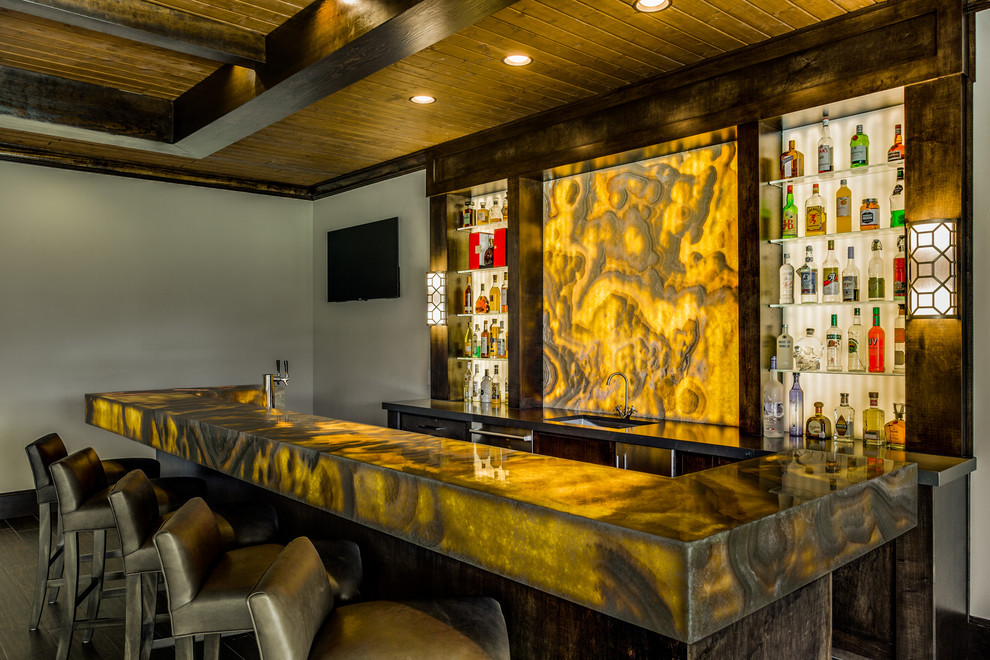 Inspiration for a contemporary seated home bar in Dallas with an undermount sink, open cabinets, onyx benchtops, yellow splashback, stone slab splashback, dark hardwood floors and yellow benchtop.