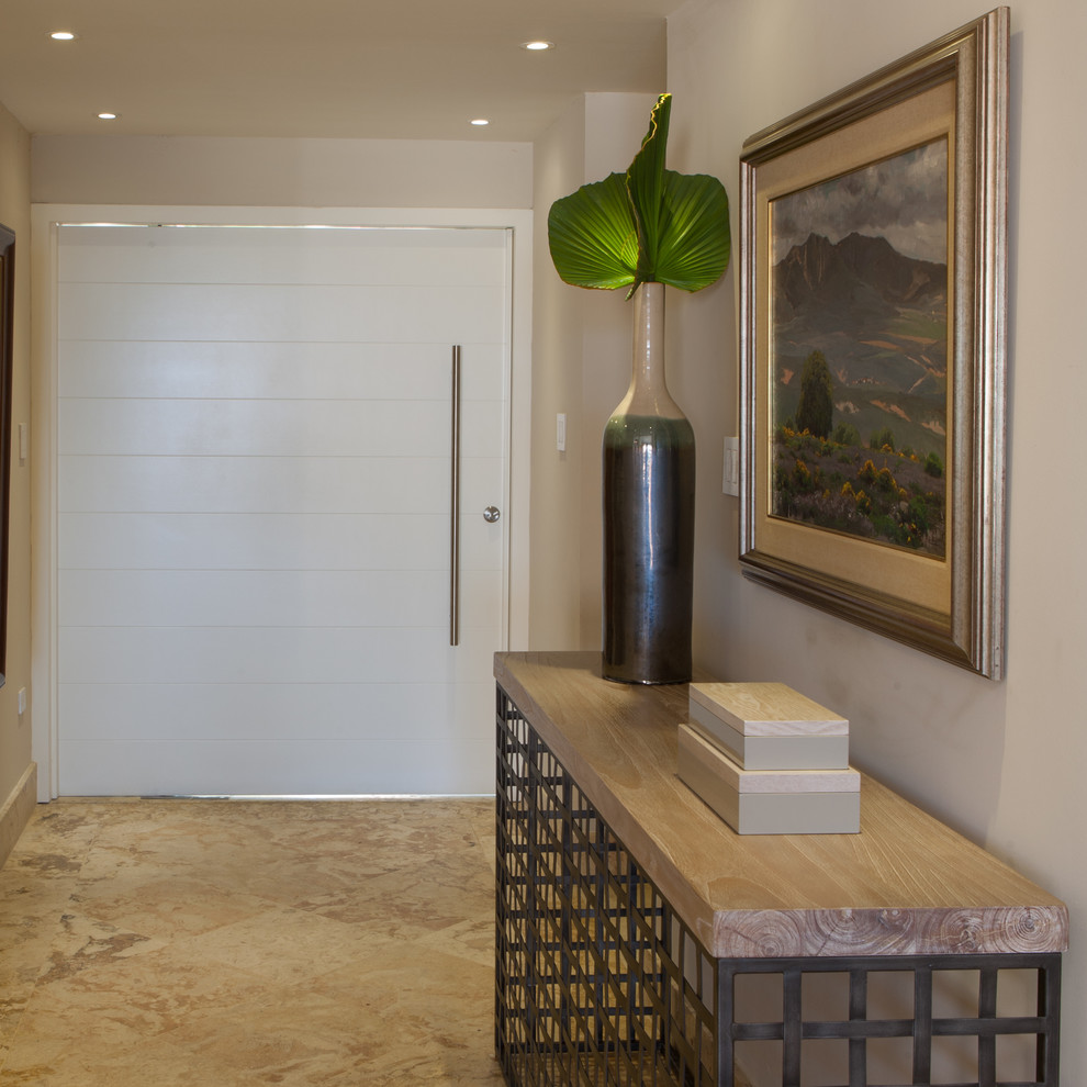 Design ideas for a large contemporary front door in Other with a pivot front door, a white front door, beige walls and limestone floors.