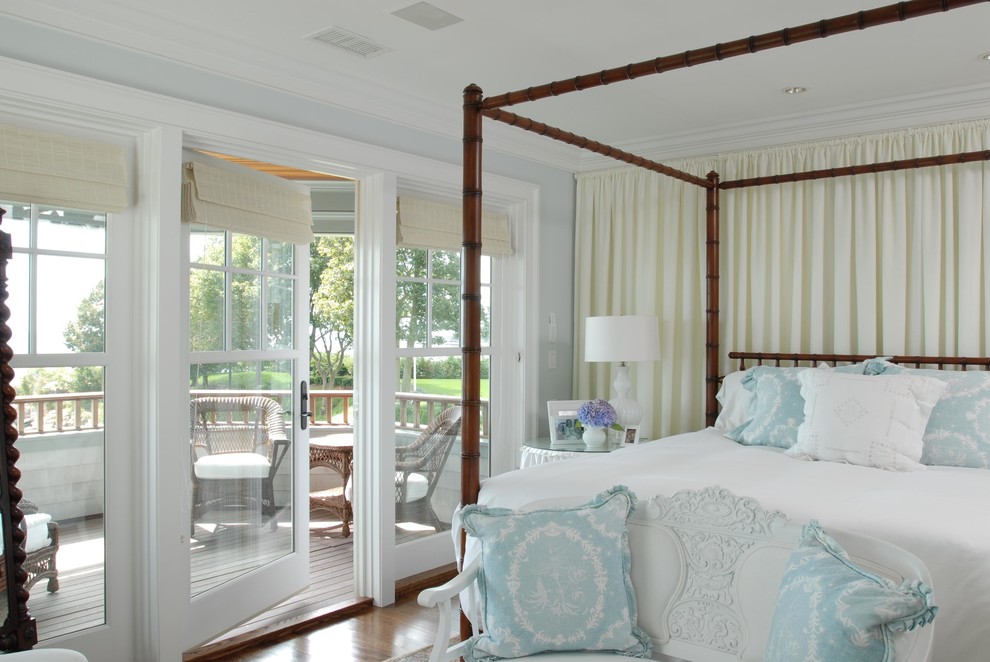 Mid-sized traditional master bedroom in New York with blue walls and medium hardwood floors.