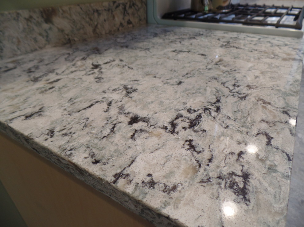 Home design - mid-sized transitional galley vinyl floor home design idea in Cedar Rapids with an undermount sink, shaker cabinets, light wood cabinets, quartz countertops, white appliances and no island