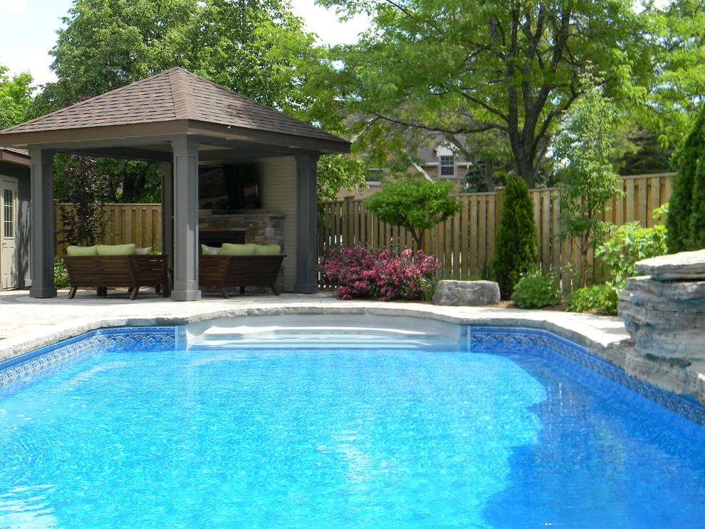 Pool house - mid-sized transitional backyard concrete paver and rectangular pool house idea in Toronto