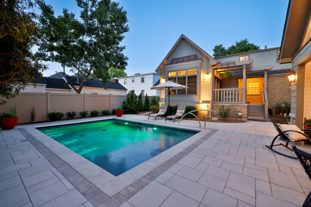 Inspiration for a small timeless backyard stone and rectangular pool house remodel in Chicago
