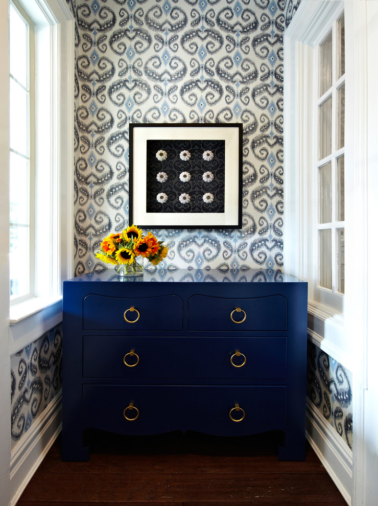 Transitional foyer in New York with dark hardwood floors, blue walls and a white front door.