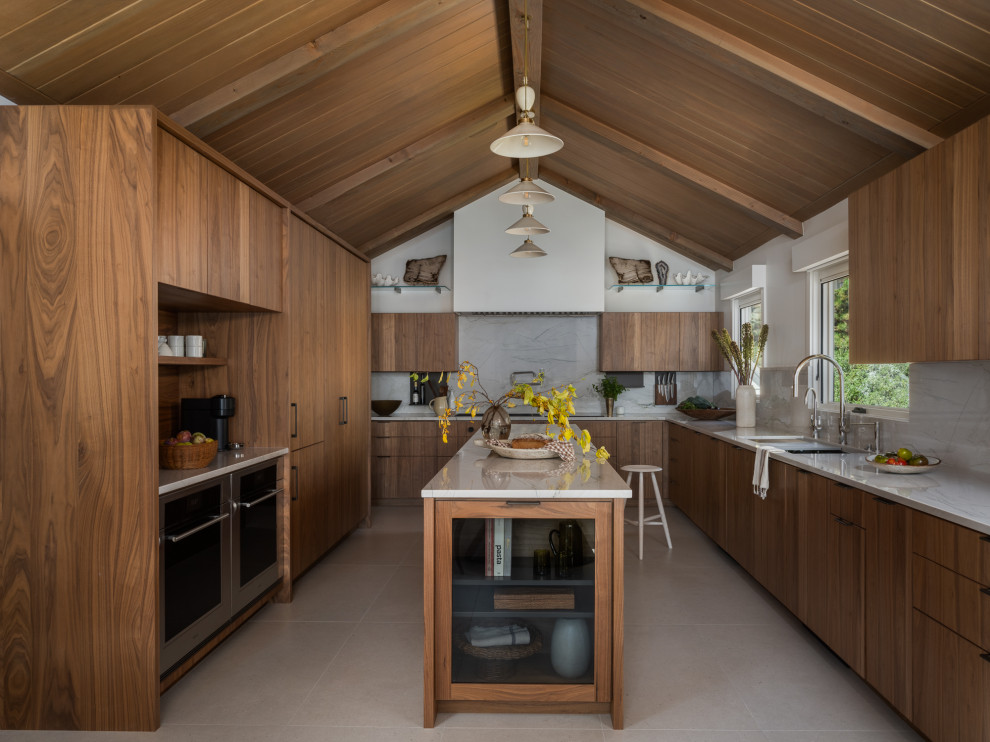 Eat-in kitchen - rustic galley porcelain tile, beige floor and exposed beam eat-in kitchen idea with flat-panel cabinets, brown cabinets, quartzite countertops, white backsplash, stone slab backsplash, paneled appliances, an island and white countertops