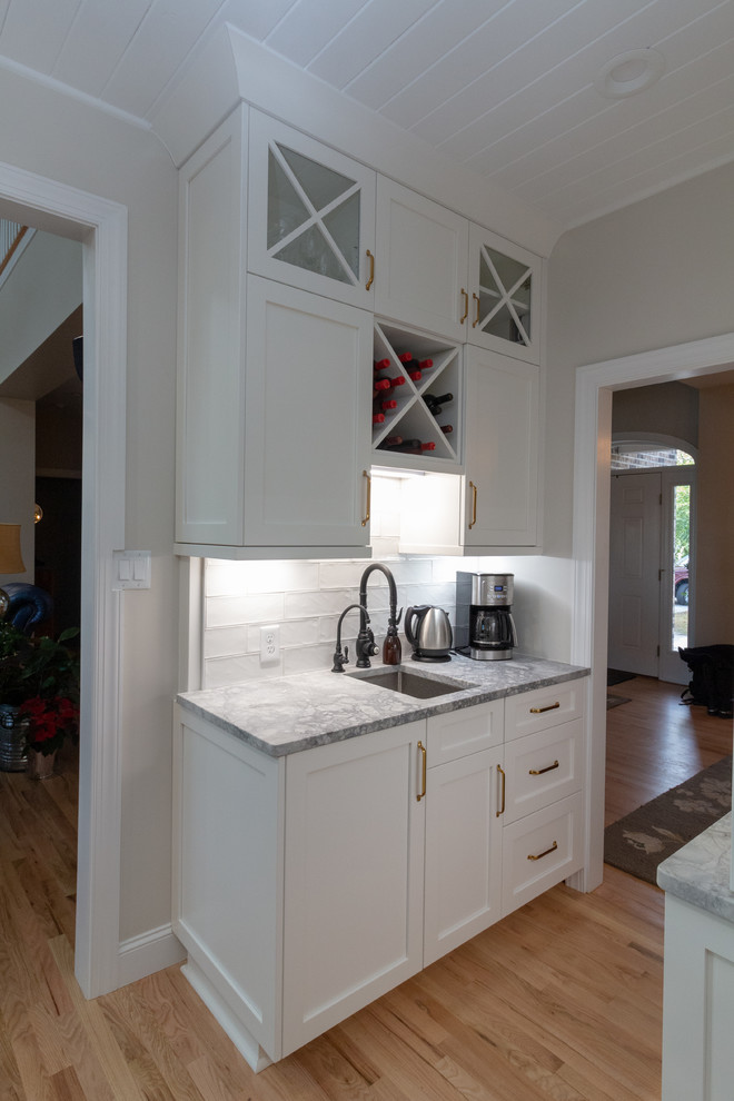 Inspiration for a large l-shaped eat-in kitchen remodel with shaker cabinets, white cabinets, granite countertops, an island and white countertops