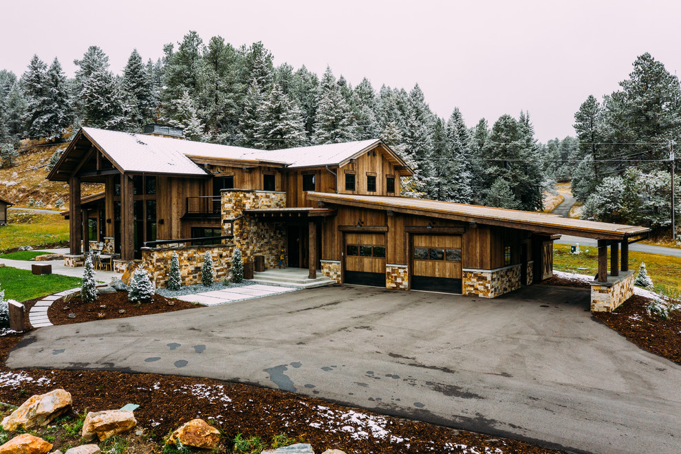 Inspiration for a country two-storey brown exterior in Denver with wood siding.
