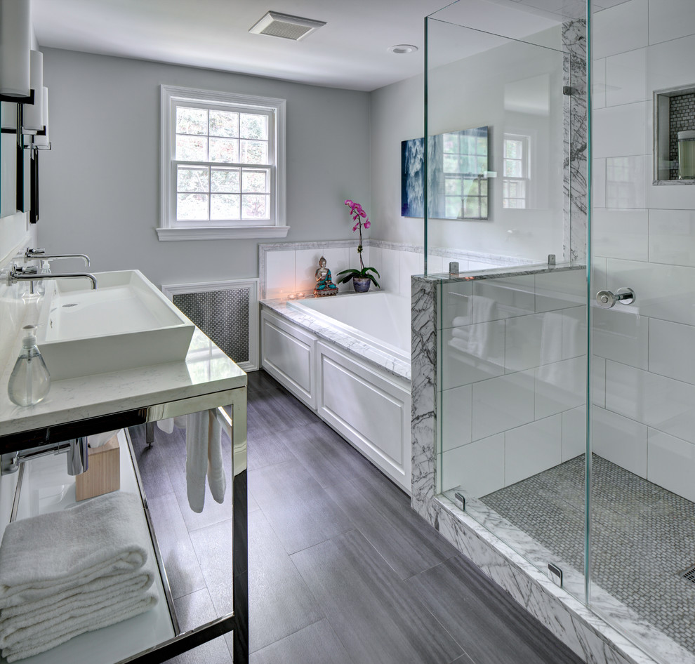 Mid-sized modern master bathroom in New York with a vessel sink, open cabinets, engineered quartz benchtops, a double shower, a two-piece toilet, gray tile, ceramic tile, grey walls, porcelain floors and a drop-in tub.