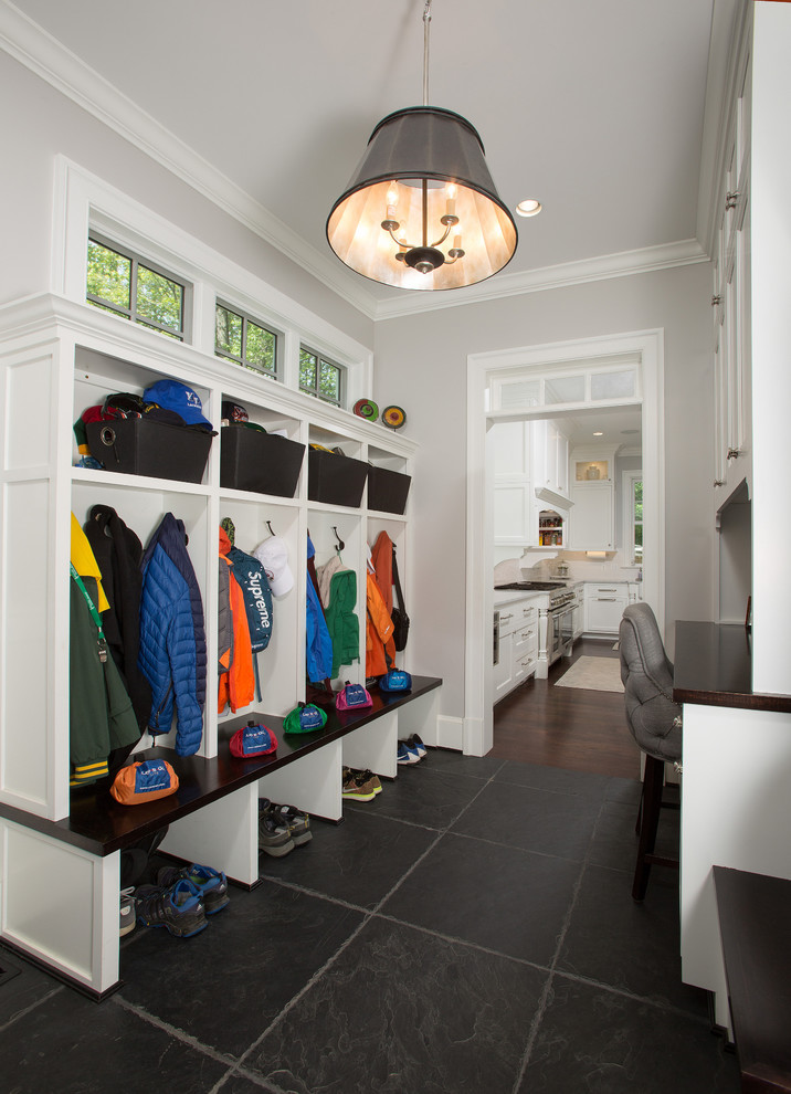 Inspiration for a mid-sized traditional mudroom in DC Metro with grey walls, slate floors, a pivot front door, a black front door and black floor.