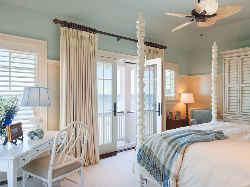 Design ideas for a mid-sized beach style master bedroom in New York with blue walls, carpet and beige floor.