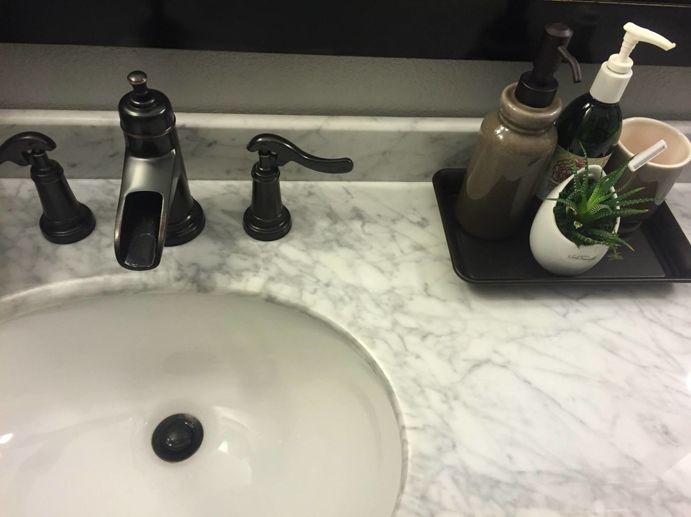 Example of a transitional bathroom design in Phoenix with marble countertops