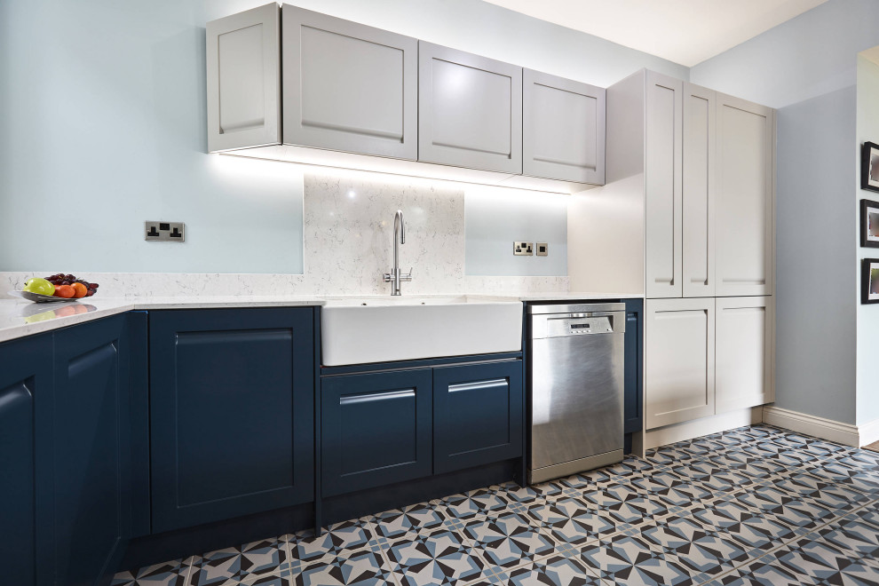 Photo of a mid-sized l-shaped eat-in kitchen in Other with a farmhouse sink, shaker cabinets, blue cabinets, marble benchtops, white splashback, marble splashback, stainless steel appliances, porcelain floors, multiple islands, blue floor, white benchtop and coffered.