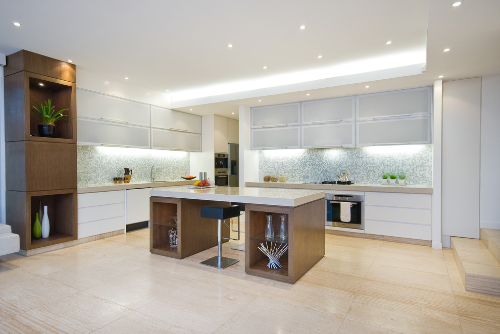 Contemporary l-shaped kitchen in Brisbane with flat-panel cabinets, white cabinets, multi-coloured splashback, mosaic tile splashback, stainless steel appliances, light hardwood floors and with island.
