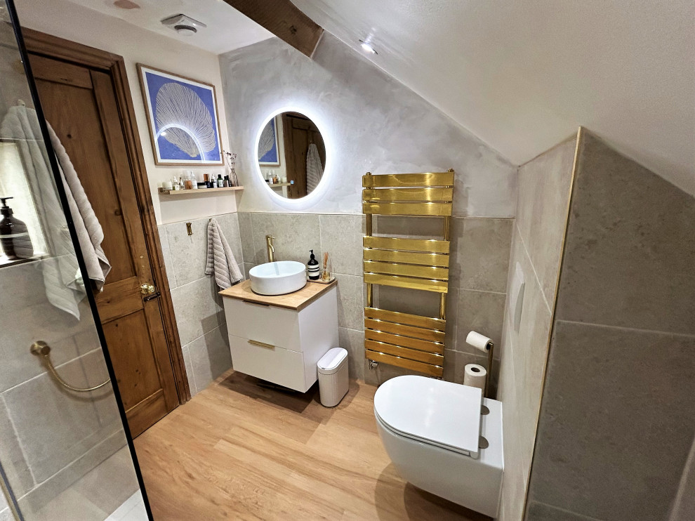 This is an example of a medium sized modern family bathroom in Other with flat-panel cabinets, white cabinets, a walk-in shower, a wall mounted toilet, beige tiles, porcelain tiles, laminate floors, a vessel sink, wooden worktops, brown floors, an open shower, a single sink and a floating vanity unit.