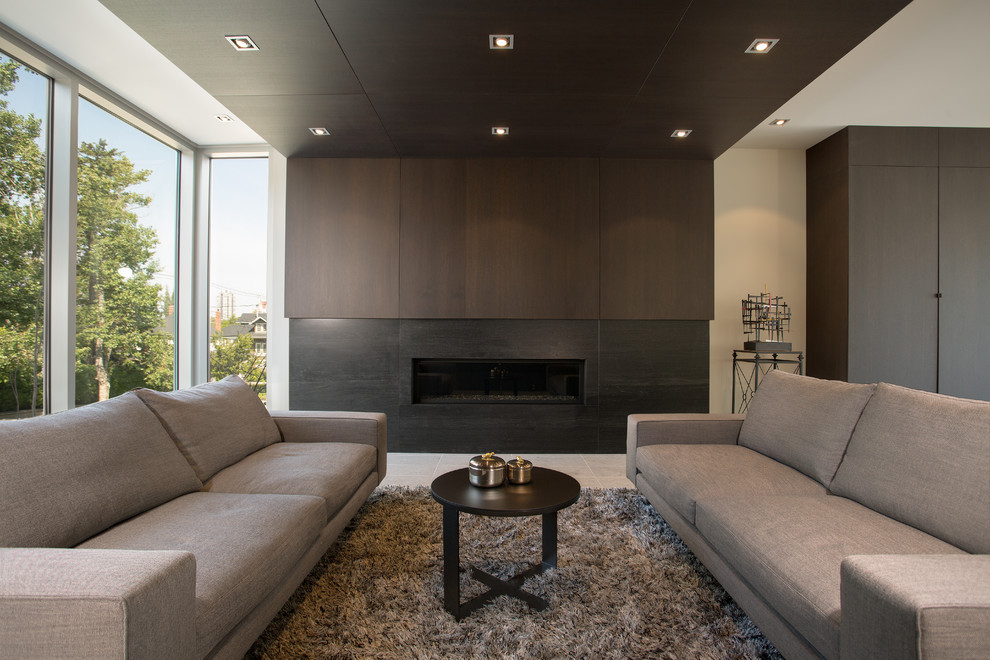 Photo of a large modern formal open concept living room in Calgary with limestone floors, beige floor, white walls, a ribbon fireplace, a tile fireplace surround and no tv.