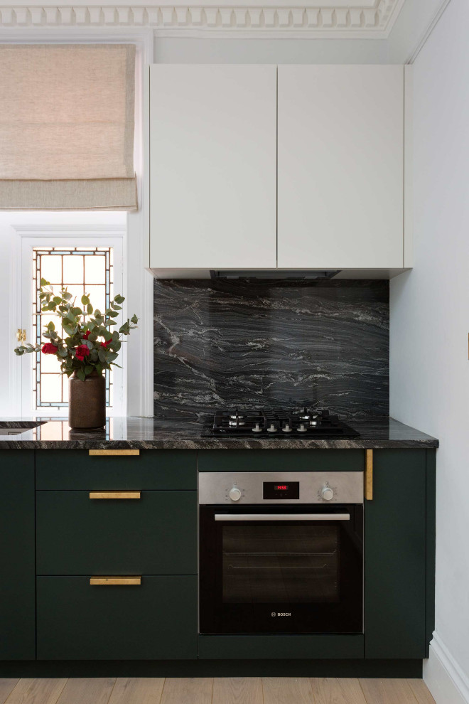 Inspiration for a medium sized modern open plan kitchen in London with granite worktops and granite splashback.