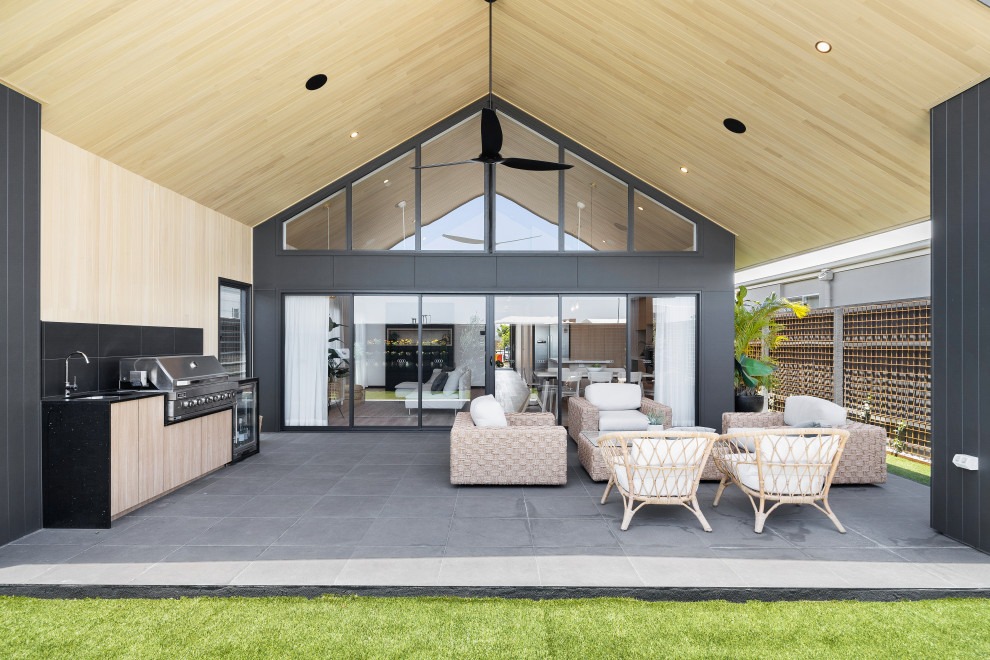 Design ideas for a contemporary patio in Sunshine Coast with tile and a roof extension.